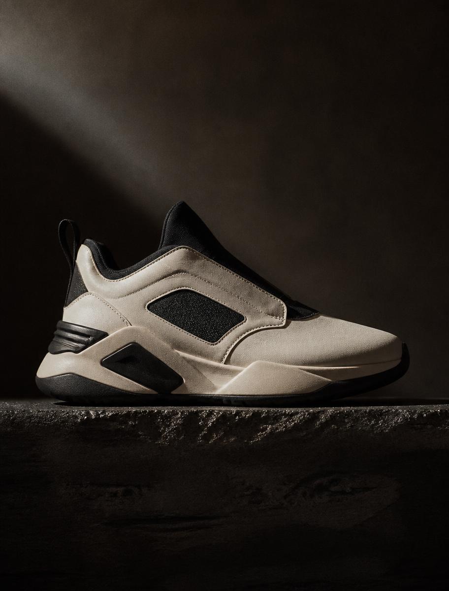 A contemporary sneaker lit by a single shaft of studio light